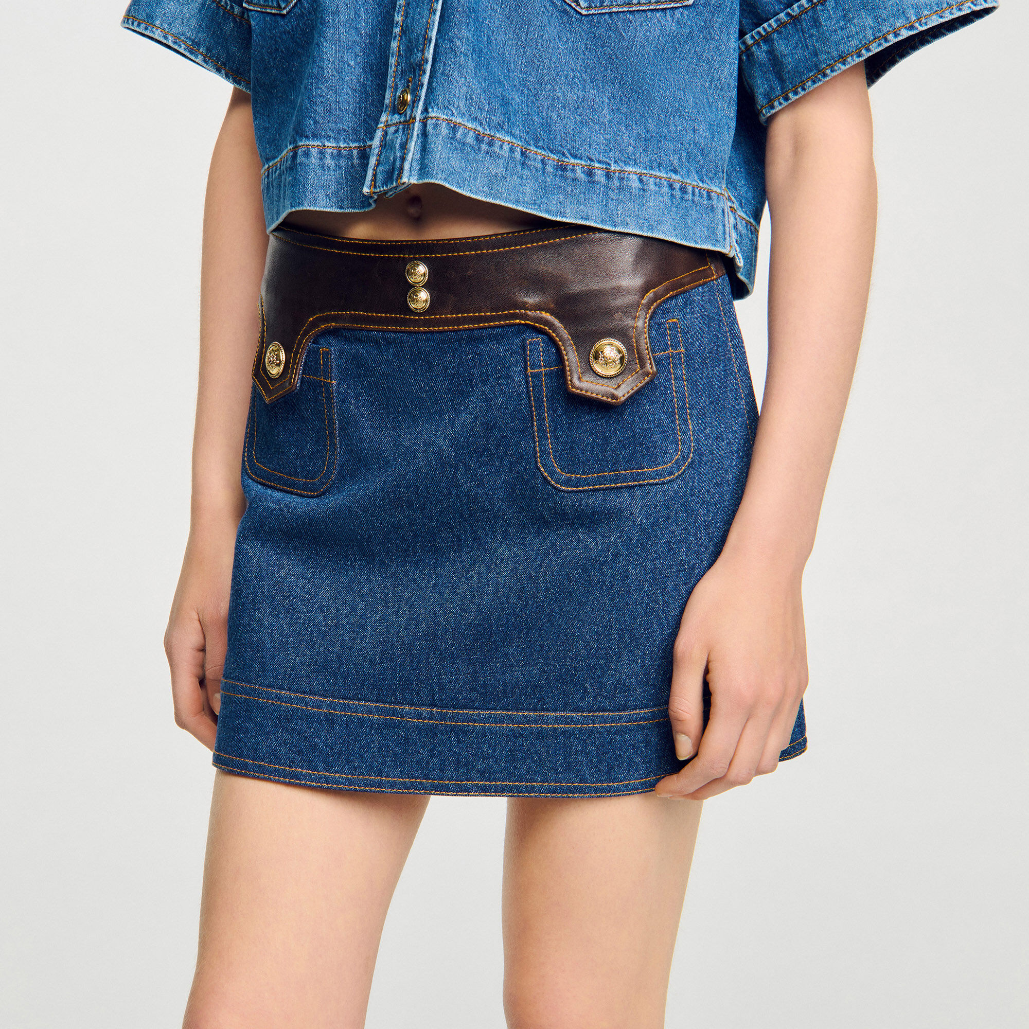 Short denim and leather skirt