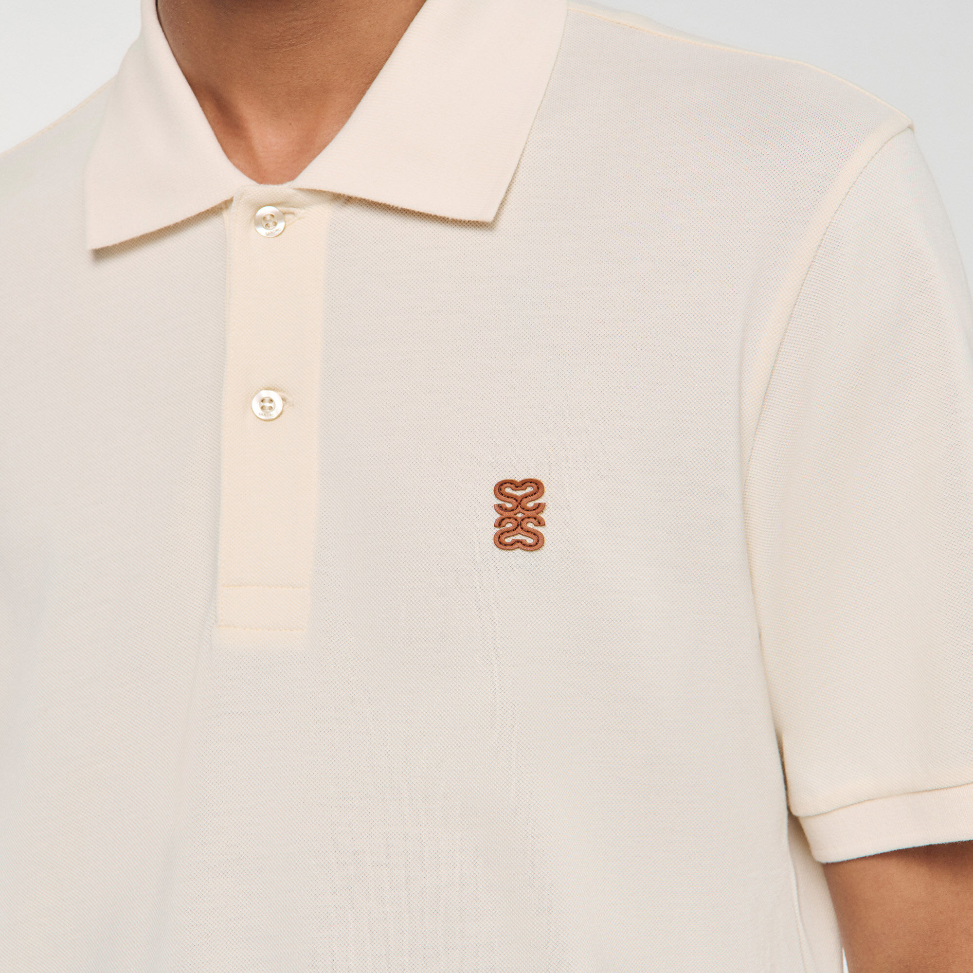Polo shirt with leather logo