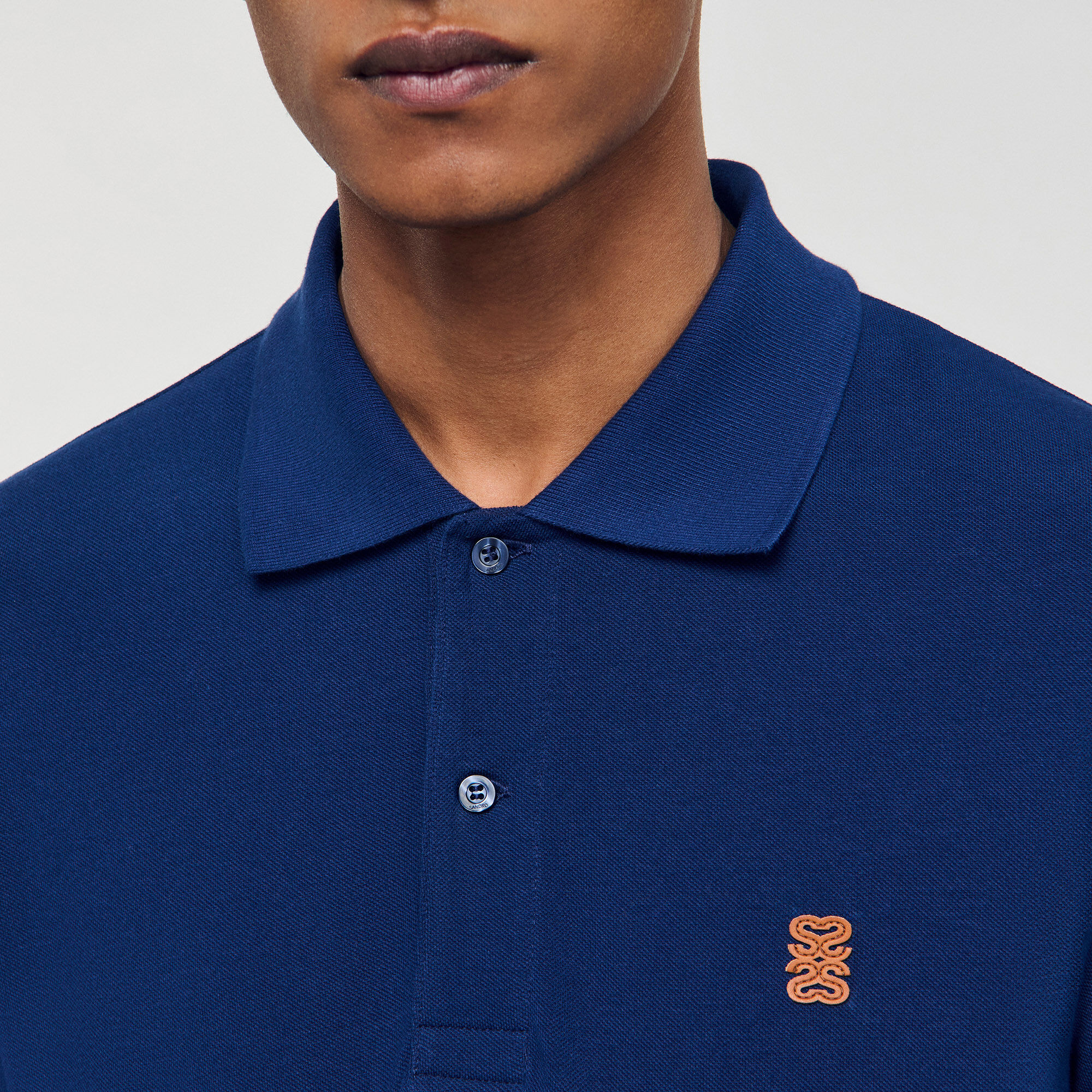 Polo shirt with leather logo Polo shirt with leather logo