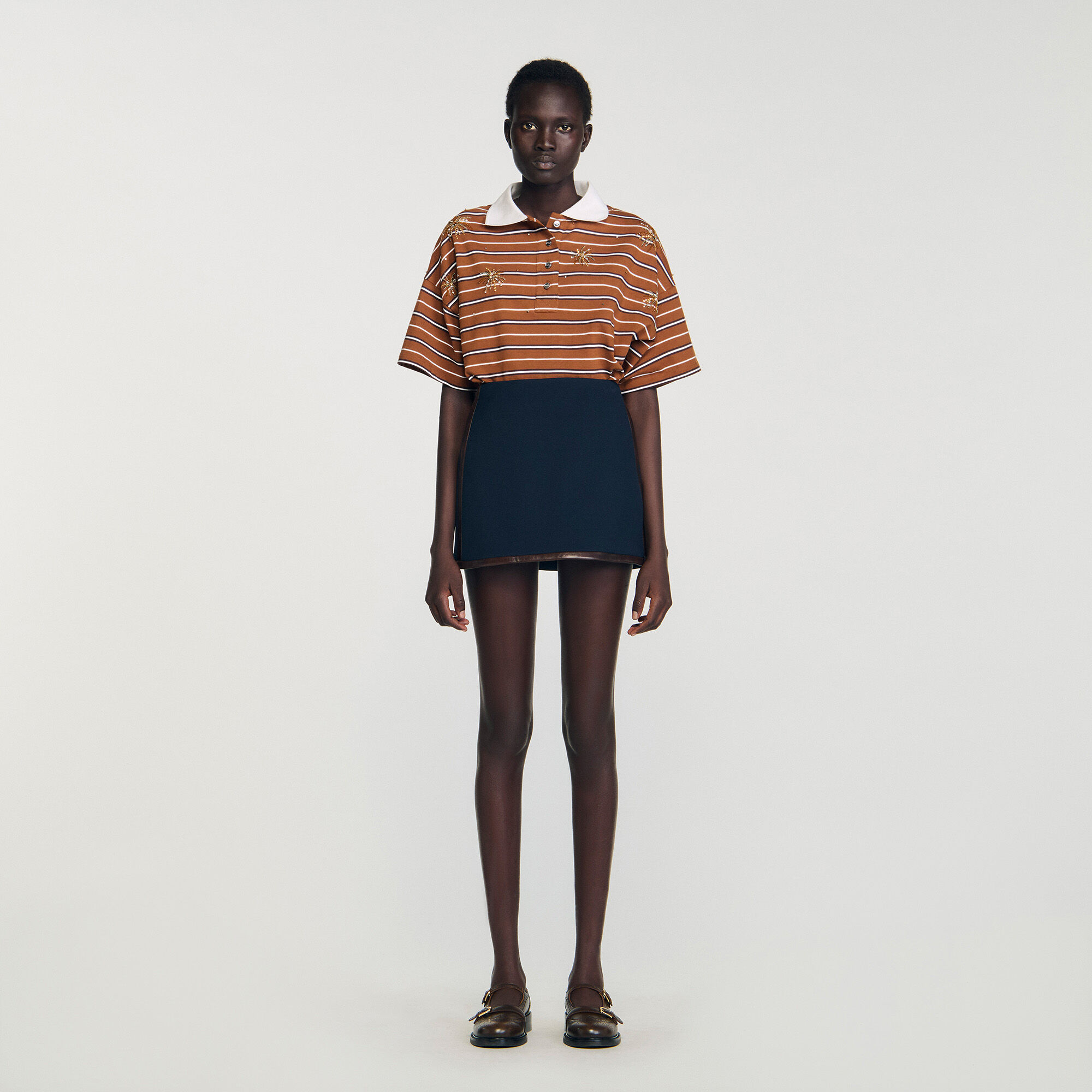 Short skirt with leather bands