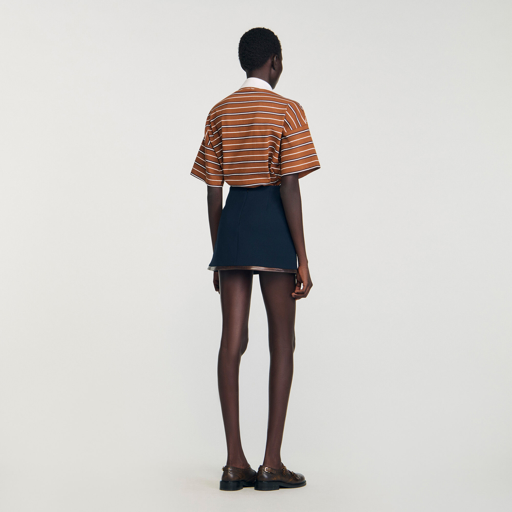 Short skirt with leather bands